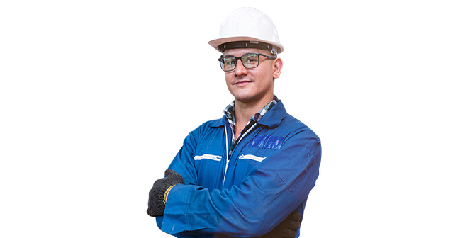 A municipal worker staring ahead with his arms crossed, wearing black glasses, a white helmet and blue clothing adorned with a white stripe